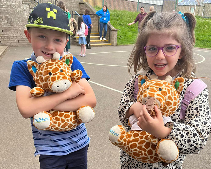 2 children each with cuddly toy Patches