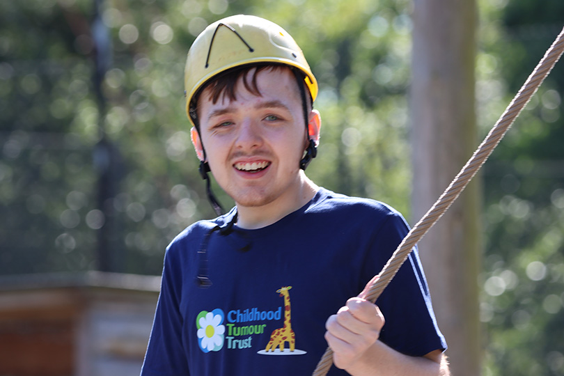Boy climbing at camp