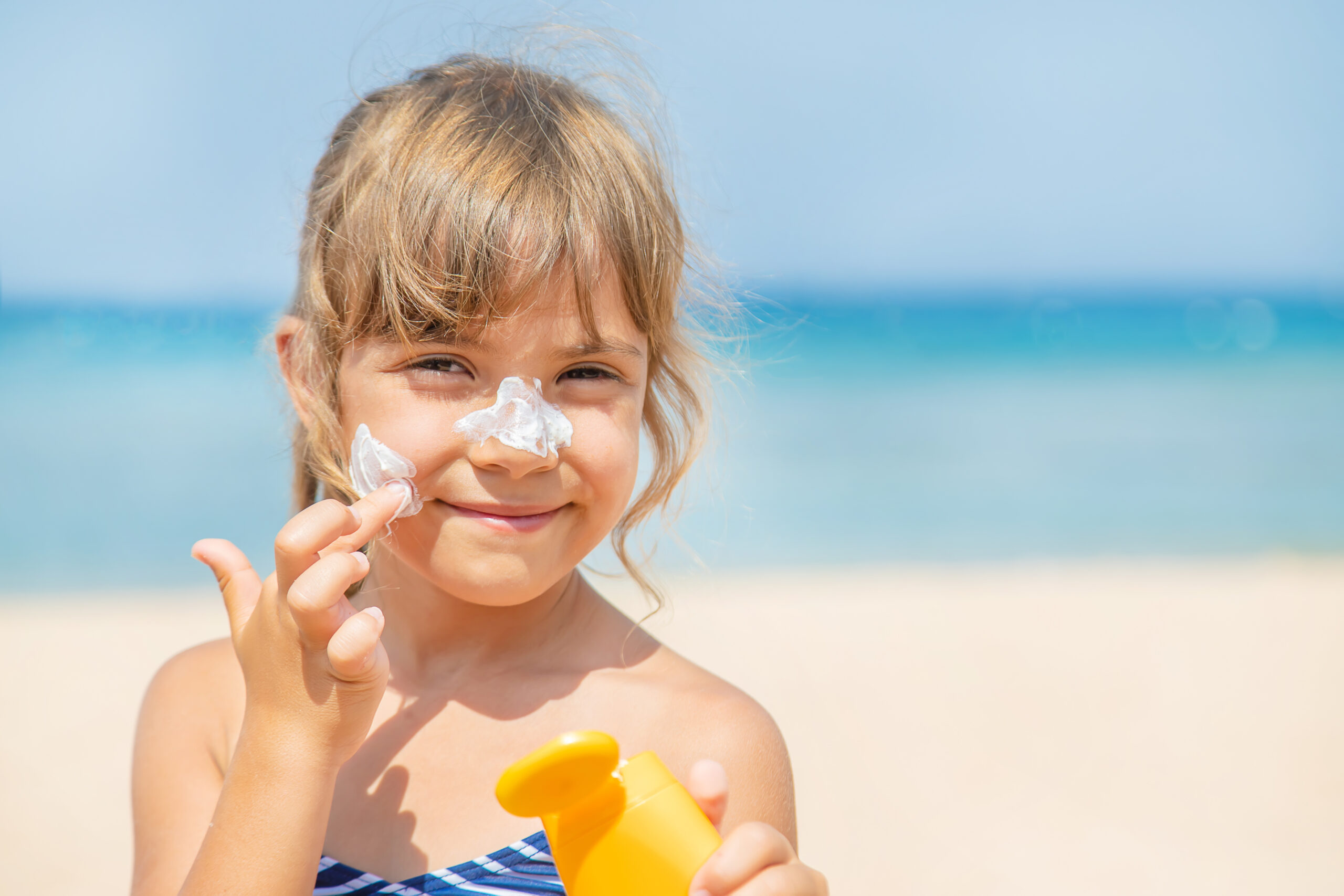 Child applying suncream