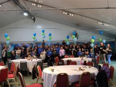 People in a hall with lots of balloons