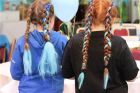 2 girls showing of their plated hair
